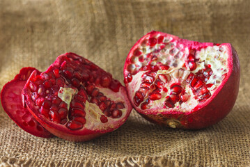 Pomegranate or grenade on a burlap background close up