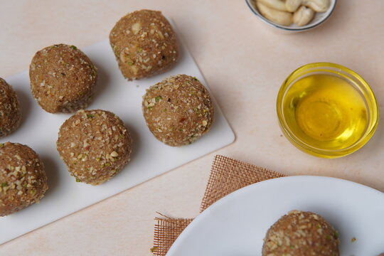 Churma Ladoo is a traditional Rajasthani Indian sweet made from coarsely crushed whole wheat flour (churma), blended with jaggery or sugar and enriched with pure ghee. Known for its rustic texture, ri
