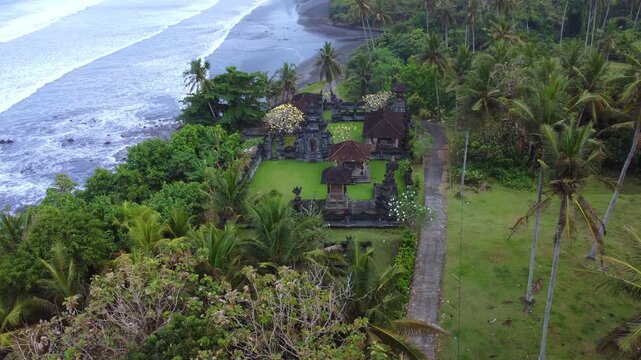 The Hindu temple of Pura Dalem from a bird's-eye view. The temple is located on Pantai Bonian Beach, which has volcanic black sand, in the Indian Ocean on the island of Bali. Dron. 4К