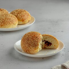 High-quality photo of traditional Indonesian onde-onde, whole and split open, showing melted palm sugar filling, crispy sesame texture, clean studio background.
