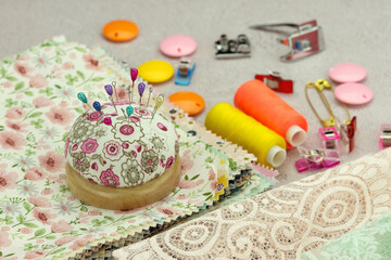 Close-up of sewing supplies. Sewing accessories and fabric scraps on a table. Crafts and hobbies.
