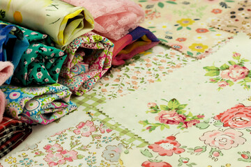 Cotton fabric scraps for patchwork and sewing. Close-up of fabric rolls.