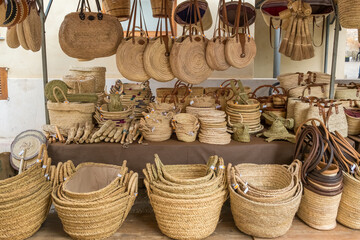 Street vendor shop with wicker baskets and handbags in Mallorca
