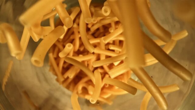 Super slow motion dry maccheroni pasta . Filmed on a high-speed camera at 1000 fps. High quality FullHD footage