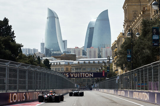 BAKU, AZERBAIJAN - SEPTEMBER 19, 2025: Max Verstappen in the Red Bull Racing car leads a Mercedes-AMG F1 car along the city straights during the Azerbaijan Grand Prix