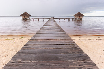 Wooden pier leading to stilt bungalows in Madagascar.