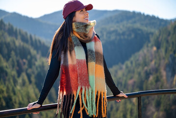Beautiful  young woman standing  in the autumn mountain with open arms