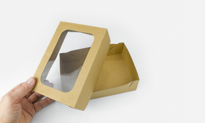 Empty brown paper box with transparent window isolated on white