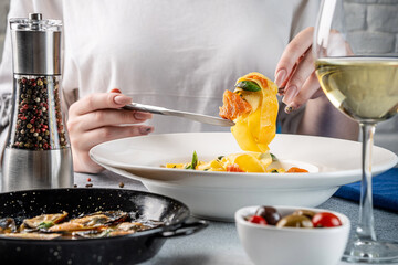 Woman Lifting Pasta With Seafood And Wine