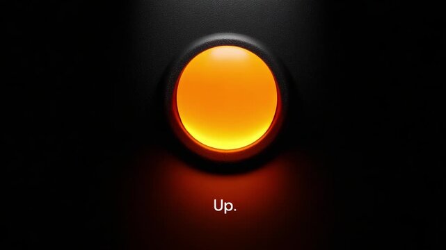 A close-up view of a glowing button marked 'Up' displayed against a dark background, capturing the transition in color and intensity across two frames of a video.