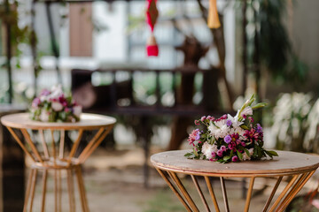 Elegant floral arrangements on ornate tables set for special occasion