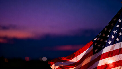 American flag waving against a vibrant twilight sky with distant lights
