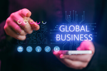 Person interacts with digital screen showing global business concepts and charts during evening hours