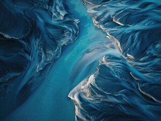 Obraz premium Aerial view of a braided river system with turquoise water flowing through textured landscapes
