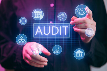 Business professional displays audit concept with digital icons in an office setting during a work meeting