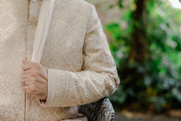 Elegant groom attire with intricate patterns and refined touch of tradition