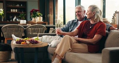 Old couple, toast champagne and celebration in home with wish, anniversary and love in living room. Elderly man, woman and smile with relationship goals, milestone and relax on sofa in retirement