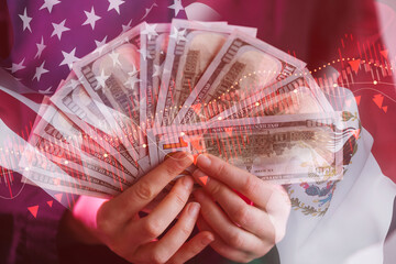 Money held in hands with American flag background and financial graphs in a busy economic setting