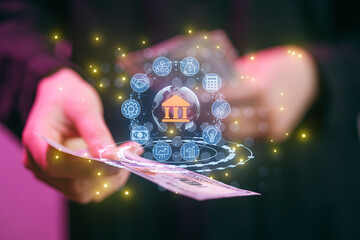 Hands holding cash with digital banking icons floating above in a modern setup during the day