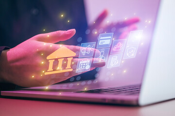 Hands interact with digital icons on a laptop screen showing services related to banking and finance