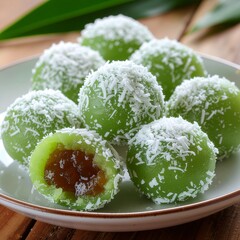 Product photo of Indonesian klepon dessert, cut open with melted palm sugar filling, clean studio background.