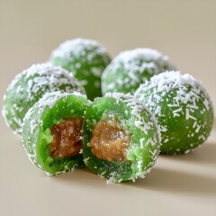 Product photo of Indonesian klepon dessert, cut open with melted palm sugar filling, clean studio background.