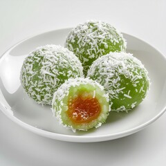 Product photo of Indonesian klepon dessert, cut open with melted palm sugar filling, clean studio background.