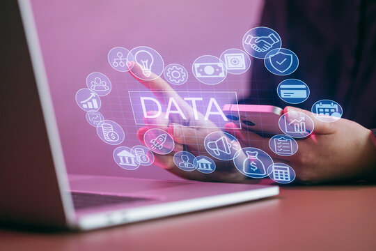 Technology and data concepts with a mobile phone and laptop on a desk during evening hours - Powered by Adobe