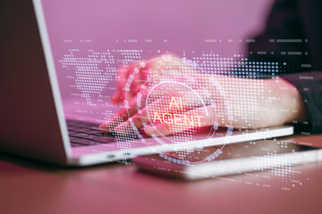 Working with AI agents on a laptop and smartphone in a digital workspace during the daytime