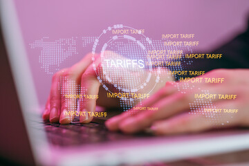 Hands typing on a laptop with import tariffs and a world map showing trade concepts at night with purple light