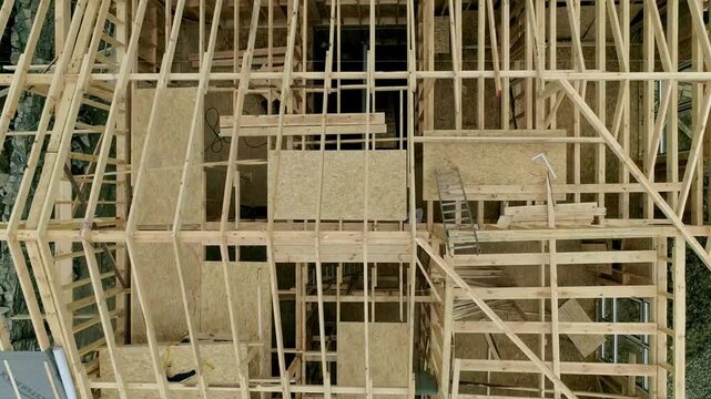 Top view to undone wood home construction, aerial view of unfinished wooden home construction. showcases ongoing craftsmanship and rural progress themes