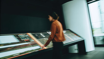 Futuristic real estate search interface concept. A person engaging with an interactive display in a modern space.