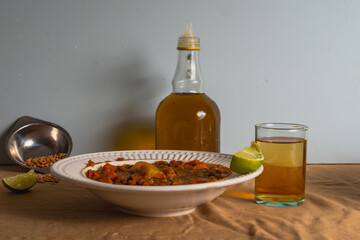 Lentil harira soup with a slice of lemon and a glass of tea