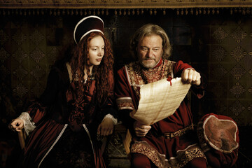 Tudor king and queen reading parchment