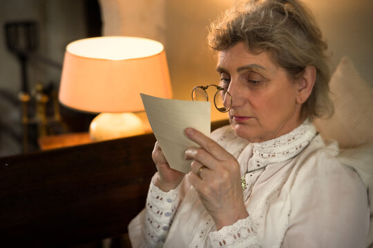 Edwardian lady reading with lorgnette