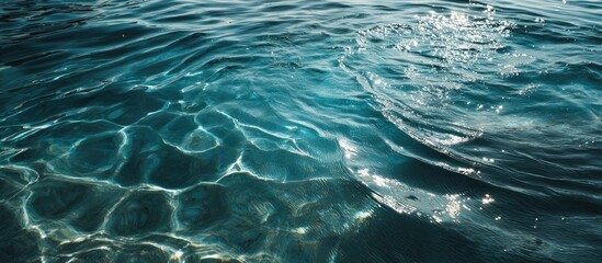 Close-up of crystal-clear ocean water with gentle ripples and sun reflections