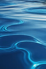 Abstract blue water surface with flowing ripples and reflections