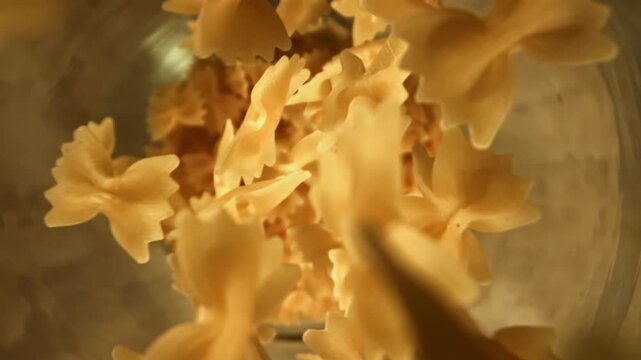 Super slow motion dry farfalle pasta . Filmed on a high-speed camera at 1000 fps. High quality FullHD footage
