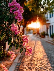 Pink flowers overlook cobblestone street in greece at sunset