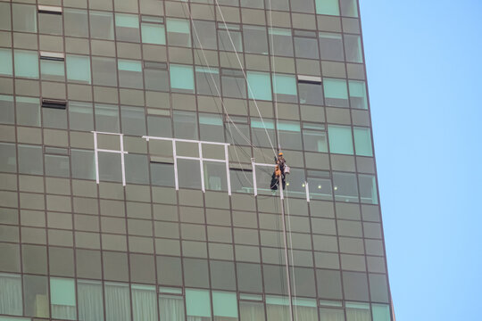 Professional climber on the glass facade