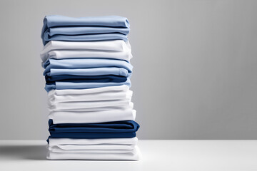 Neatly stacked blue and white fabric piles on a clean surface with copy space