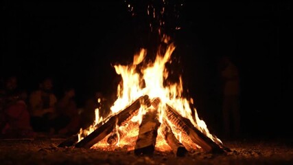 holi colour holiday 2026 Group of people gathered around a bonfire at night with flames rising high in a joyful celebration with gathering and warmth and social and event with outdoor holiday 2026