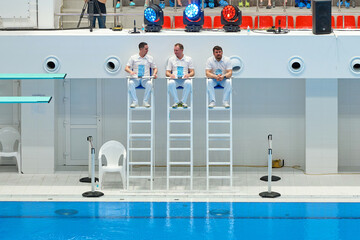 Diving judges are sitting by the pool