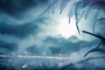 Fog covers the landscape with a focus on plants near a railway during nighttime with dim light in the background