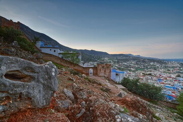 Northwest-to-southeast view of the historic walled town -medina- and parts of the new town under the blue sky of a clear dawn. Chefchaouen-Morocco-020