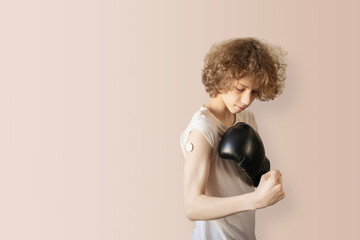 Diabetes Management Concept with Boy and Boxing Glove against Pastel Backdrop. Empowering Healthcare Visuals for Medical Campaigns, inclusive Youth Representation, and active Chronic Illness Lifestyle