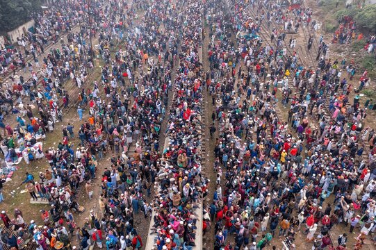 Tongi, Bangladesh - 12 January 2020: Aerial view of a sea of people, a dense crowd, spilling onto train tracks near Tongi Rail Station Road, a vibrant, bustling scene.