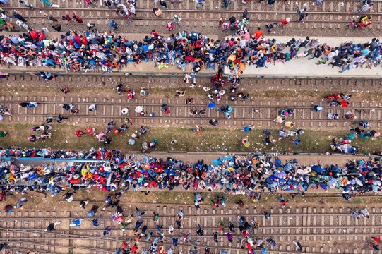 Tongi, Bangladesh - 12 January 2020: Aerial view of the crowded railway tracks near Tongi Rail Station Road, a tapestry of humanity amidst the parallel lines of steel and concrete.
