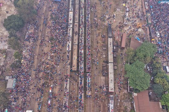Tongi, Bangladesh - 12 January 2020: Aerial view of the bustling Tongi Rail Station Road, teeming with crowds amidst the trains and vibrant market stalls.