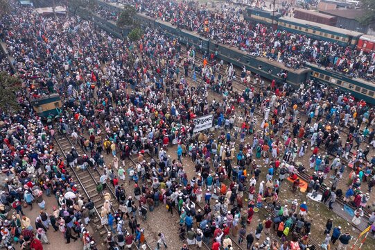 Tongi, Bangladesh - 12 January 2020: Aerial view of a vast crowd gathered near the Tongi Rail Station, spilling onto the tracks and train carriages.